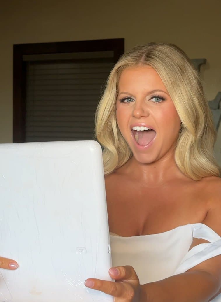 Blonde client reacting to her finished glam — special event makeup reveal